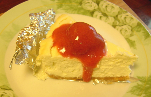 [a slice of cheesecake with strawberry sauce]